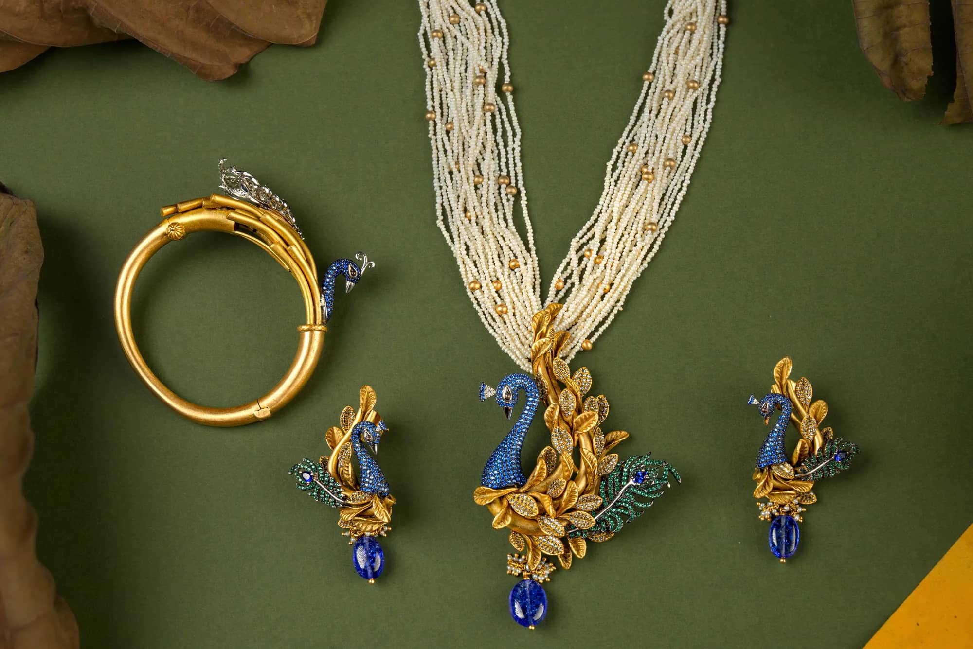Peacock pendant on seed-pearl strands — Antique Gold