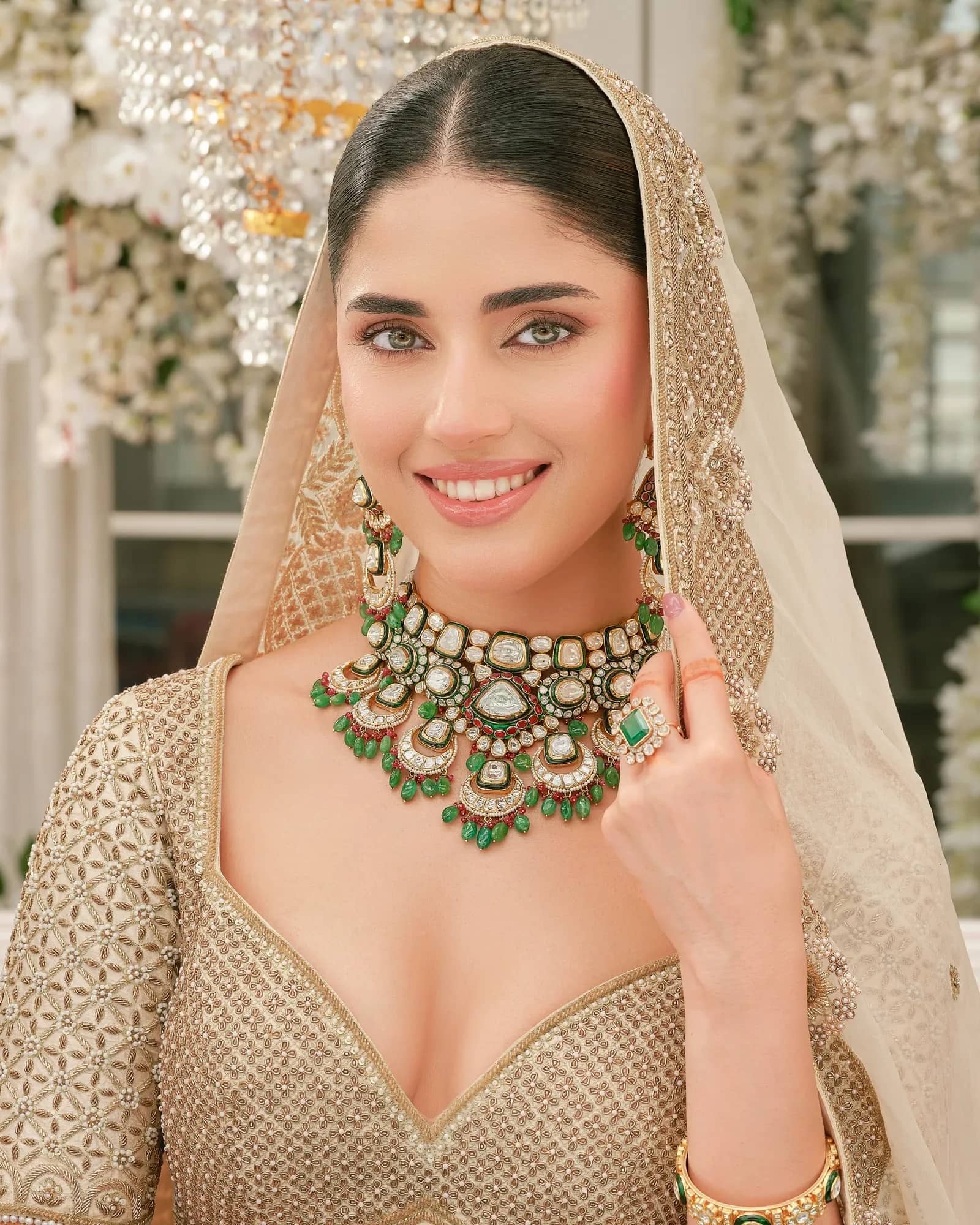 A bride in a polki bridal choker beneath her dupatta